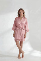 Woman wearing a pink robe on a white background