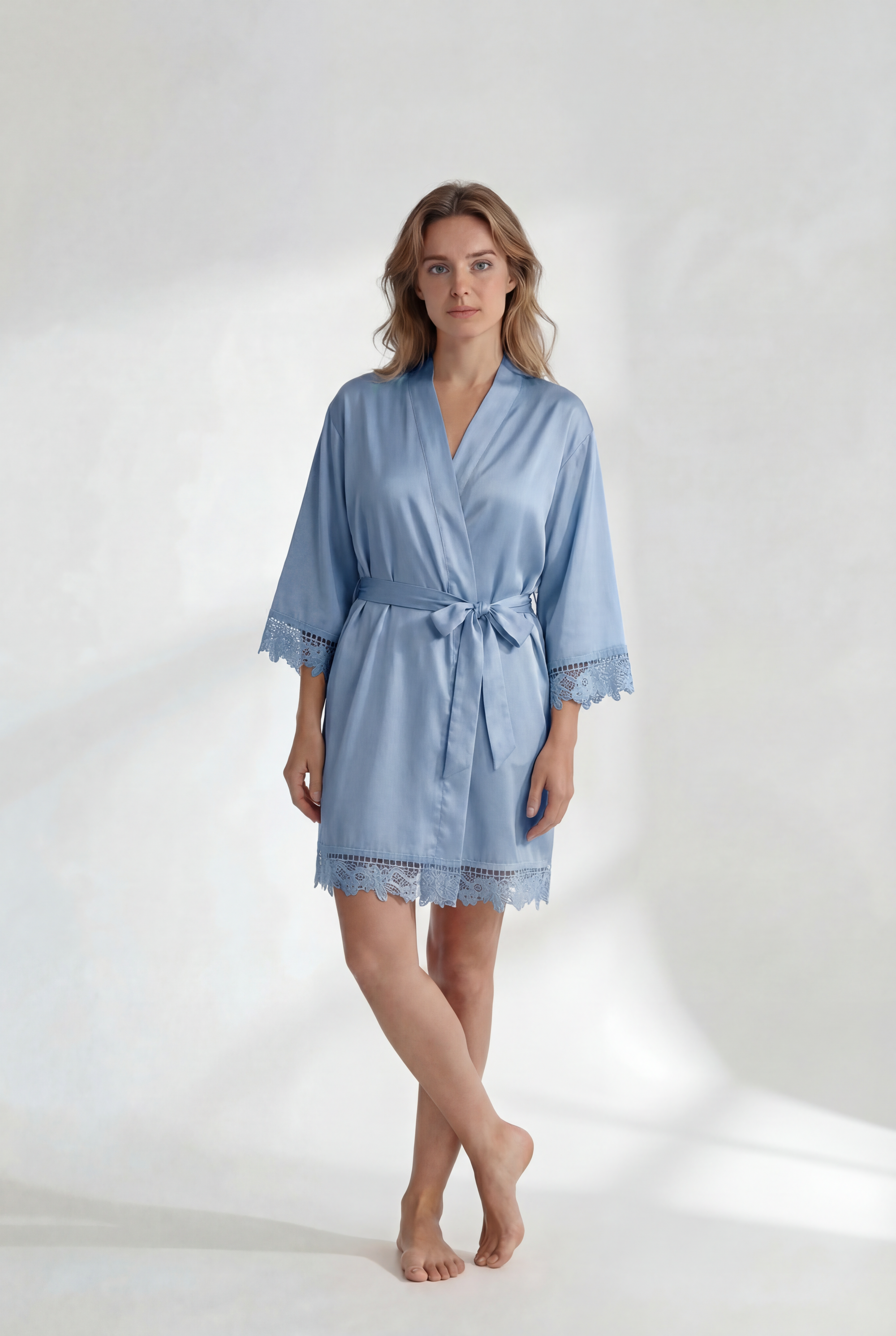 Woman wearing a light blue robe on a white background