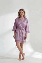 Woman wearing a light purple robe on a white background