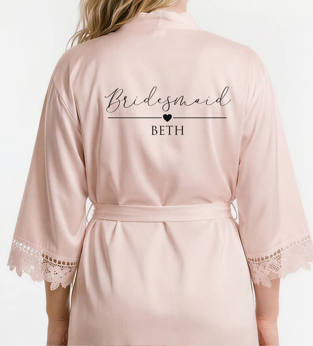 Pink bridesmaid robe with 'Bridesmaid BETH' text on a white background