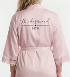 Pink satin robe with 'Bridesmaid BETH' text on a white background