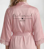 Pink satin robe with 'Bridesmaid BETH' text on a white background