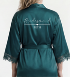 Teal satin robe with 'Bridesmaid BETH' text on a white background
